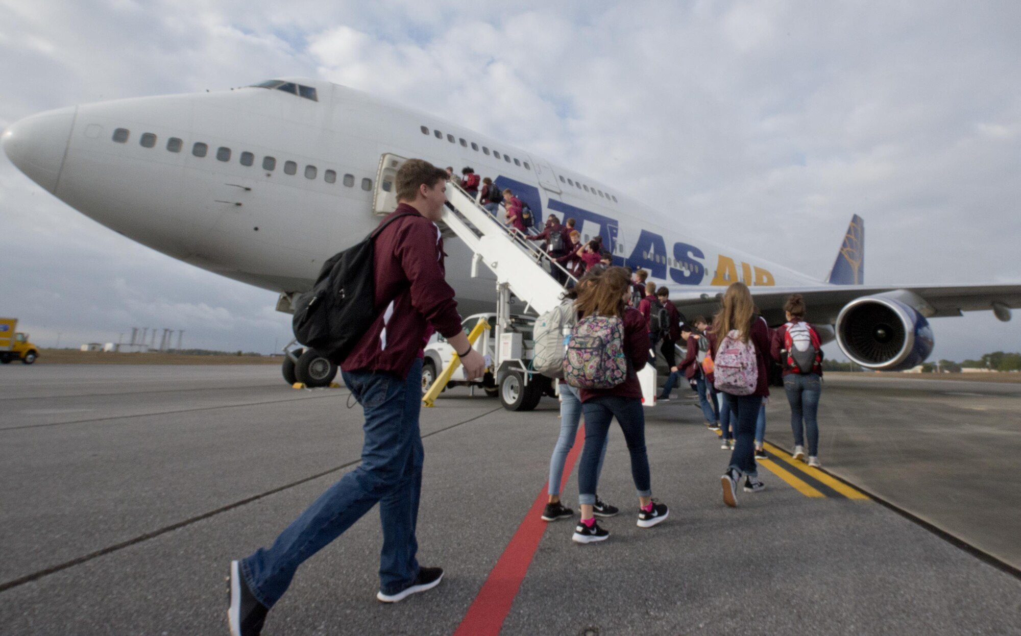 Over 300 Niceville High School band students and staff members board on Eglin’s flight line Dec. 29 traveling for their performance in the 2017 Tournament of Roses Parade in California. The crew of five loadmasters, also known as the ‘port dogs’ loaded nearly 82,000 pounds of equipment in less than two hours. (U.S. Air Force photo/Kristin Stewart)