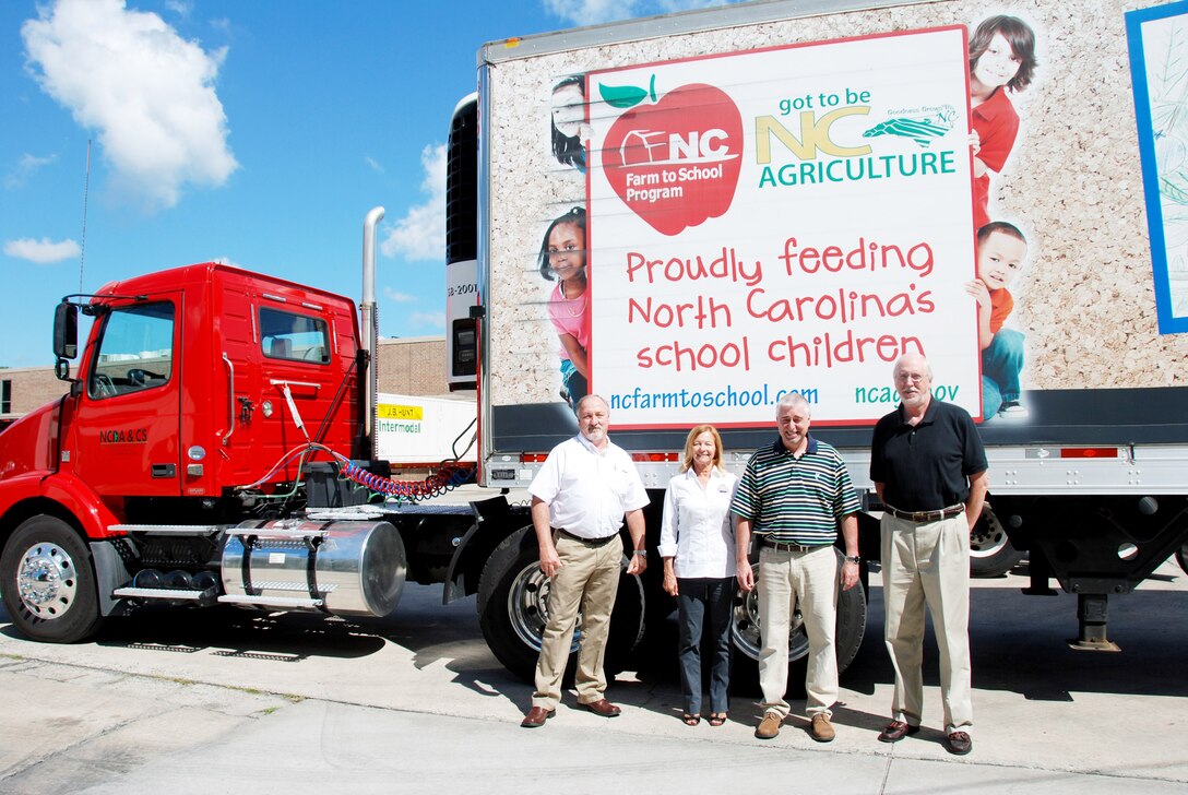 (From left)  Ken Wilmoth and Pam Hamlett from DLA Troop Support stand in front of the North Carolina Department of Agriculture’s Farm to School truck with NCDA’s warehouse administrator, Ted Fogleman, and Bob Sitton, NCDA assistant director. 