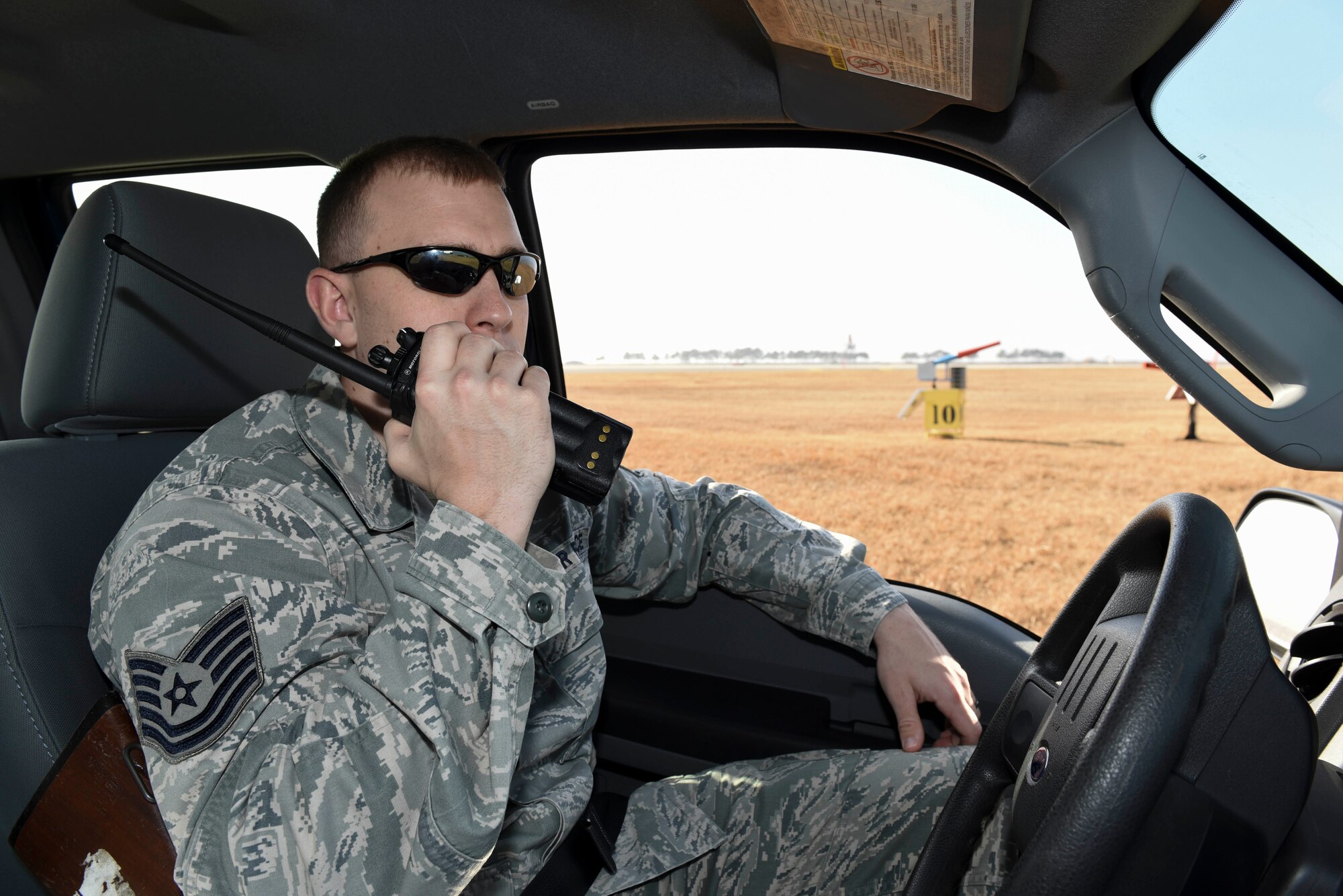 Tech. Sgt. Blake Fagan, 8th Operations Support Squadron aircraft management training noncommissioned officer in charge, uses his radio to call in a noise cannon discharge at Kunsan Air Base, Republic of Korea, Jan. 3, 2017. Fagan is a member of the Bird/wildlife Aircraft Striking Hazard program. He uses a variety of tools from noise cannons and predator calls to shotguns to deter wildlife that could cause significant damage to aircraft. (U.S. Air Force photo by Senior Airman Michael Hunsaker)