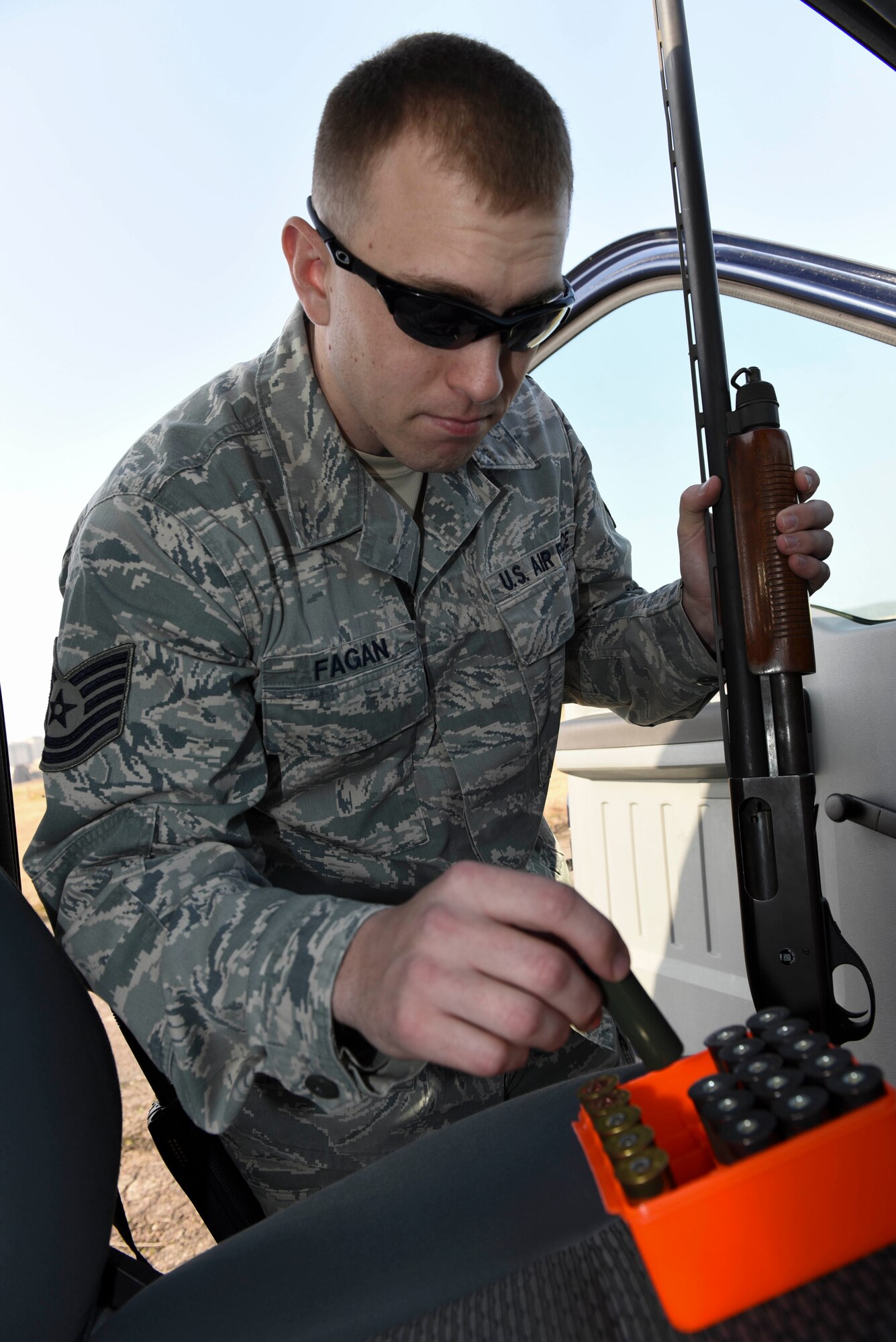 Tech. Sgt. Blake Fagan, 8th Operations Support Squadron aircraft management training noncommissioned officer in charge, picks up ammunition for his shotgun at Kunsan Air Base, Republic of Korea, Jan. 3, 2017. Fagan uses multiple tools as part of the Bird/wildlife Aircraft Striking Hazard program to deter wildlife that could cause significant damage to aircraft. (U.S. Air Force photo by Senior Airman Michael Hunsaker)