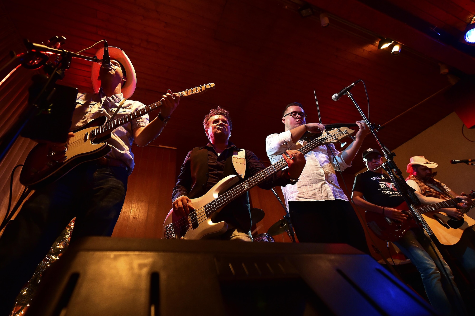 U.S. Army Warrant Officer Jonathan Reed, 603rd Air and Space Operations Center, 19th Battlefield Coordination Detachment airspace management officer in charge (left), leads Roll ‘N’ Rock in a song during a concert at the Red Barn, Kaiserslautern, Germany, Dec. 17, 2016. Reed, a Waller, Texas, native, uses his love of music to bring Germans and Americans together through country-western storytelling. (U.S. Air Force photo by Senior Airman Jonathan Bass)