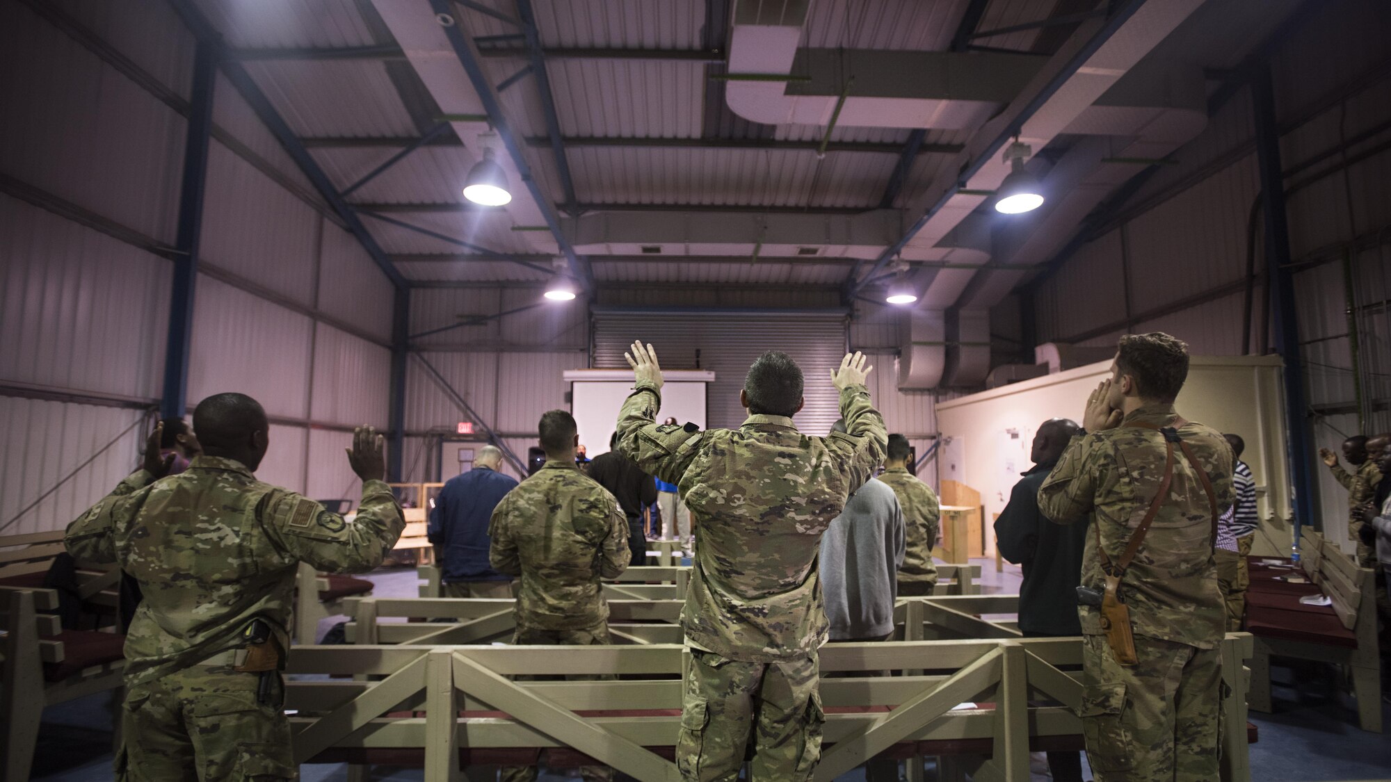 Service members, Defense Department civilian employees and contractors sing during a service Jan. 1, 2016 at the Warrior Chapel, Bagram Airfield, Afghanistan. In addition to chapel services, the 455th Air Expeditionary Wing chaplains provide counseling, enhance morale and provide accommodations for all faiths throughout the units assigned here. (U.S. Air Force photo by Staff Sgt. Katherine Spessa)