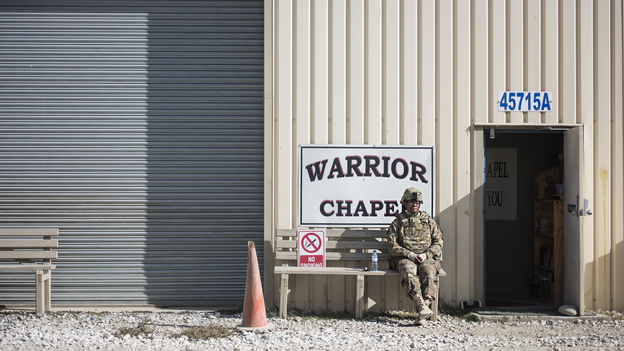 Staff Sgt. Krizia Gibson, 455th Air Expeditionary Wing chaplain assistant, sits outside of the Warrior Chapel before a service held Jan. 1, 2016 at Bagram Airfield, Afghanistan. Chaplains with the 455th AEW, alongside their sister service partners, provide several worship services throughout the week at the chapels around Bagram as well as providing accommodations for all religious backgrounds. (U.S. Air Force photo by Staff Sgt. Katherine Spessa)