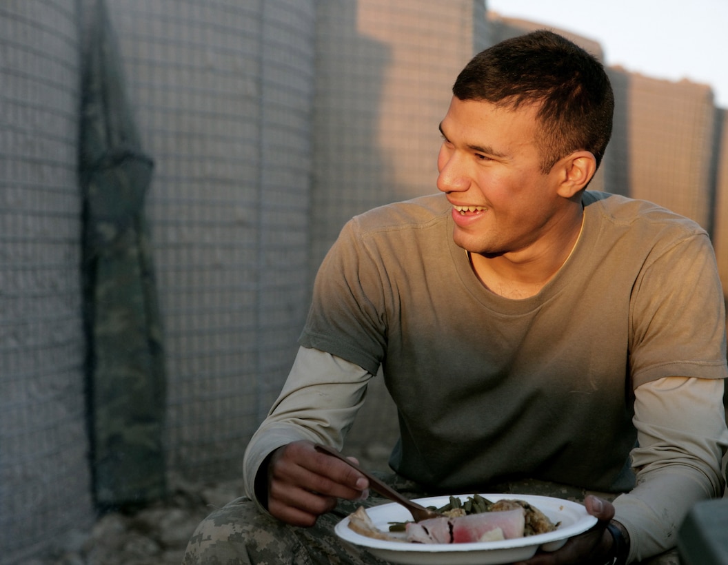 U.S. Army Pfc. Oziel Villanueva eats his Thanksgiving meal on Combat Outpost Cherkatah, Khowst province, Afghanistan, Nov. 26, 2009. Villanueva is deployed with Company D, 3rd Battalion, 509th Infantry Regiment.