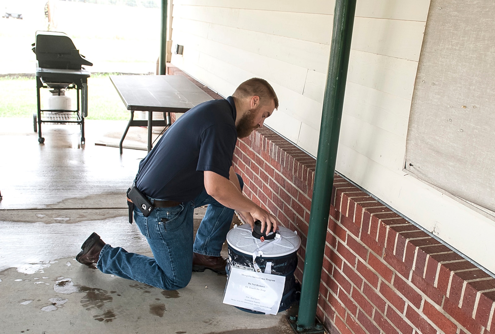 Brad Sparks, a pest controller at DLA checks a mosquito trap to see if any live specimens have been captured. Each week Sparks collects the samples and sends them to a laboratory to test for the presence of the Zika virus.