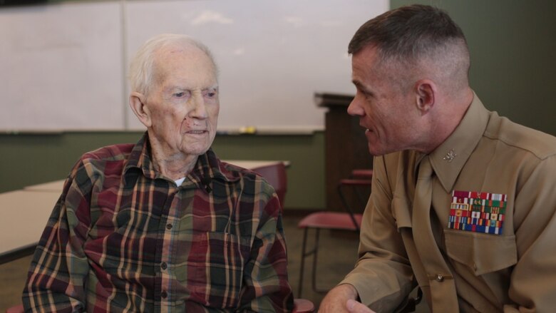 Col. Thomas M. Fahy (right) speaks with retired 1st Lt. John J. O’Leary (left), a Marine veteran of World War II, at the Evergreen Community of Johnson County, Olathe, Kansas, Dec. 21, 2016. O’Leary fought on Guam and witnessed the bombardment of Iwo Jima as a member of 3rd Joint Assault Signal Company. He celebrated his 100th birthday on Dec. 23.