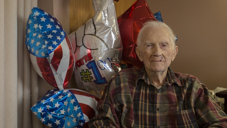 Retired 1st Lt. John J. O’Leary sits in front of birthday balloons at the Evergreen Community of Johnson County, Olathe, Kansas, Dec. 21, 2016. O’Leary fought on Guam and witnessed the bombardment of Iwo Jima as a member of 3rd Joint Assault Signal Company. He celebrated his 100th birthday on Dec. 23. 