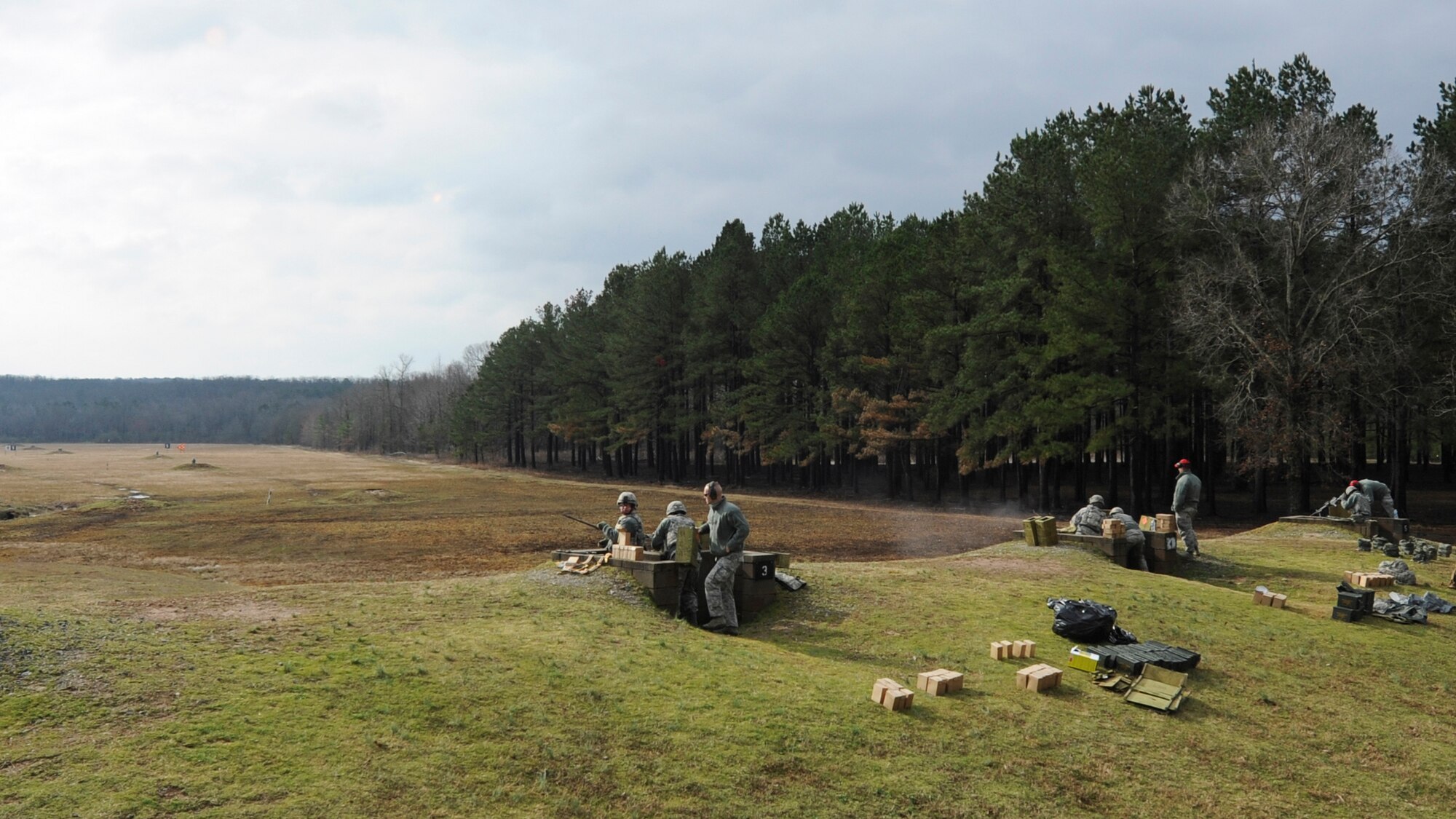 U.S. Air Force Airmen from the 19th Security Forces Squadron and 189th Security Forces Squadron simultaneously work together during M240B machine gun training, February 24, 2016, at Camp Joseph T. Robinson, Ark. Security Forces Defenders must routinely qualify on a variety of weapons and ranges. (U.S. Air Force photo/Senior Airman Harry Brexel) 