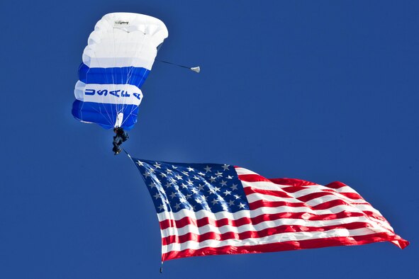 A U.S. Air Force Academy cadet from the Wings of Blue demonstration team displays the U.S. Flag midair. (U.S. Air Force photo/Airman 1st Class Jason Couillard)