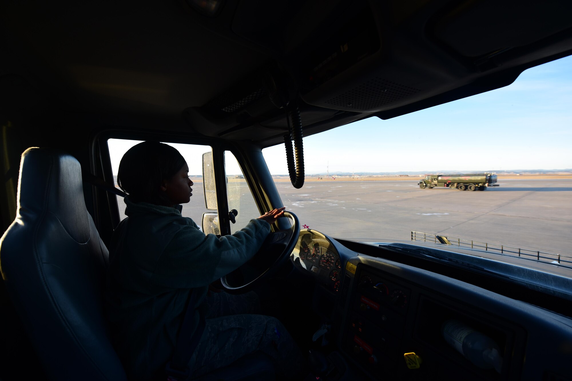 Airman 1st Class Shontaedrian Bills a fuels distribution operator assigned to the 28th Logistics Readiness Squadron, prepares to refuel another fuel truck at Ellsworth Air Force Base S.D., Dec. 14, 2016. In addition to providing fuel to vehicles as well as the B-1, the distribution flight also inspect vehicles to ensure fluid levels, hose pressure, and lights work keeping the fleet of 15 refueling vehicles ready and serviceable at all times. (U.S. Air Force photo by Airman 1st Class James L. Miller)