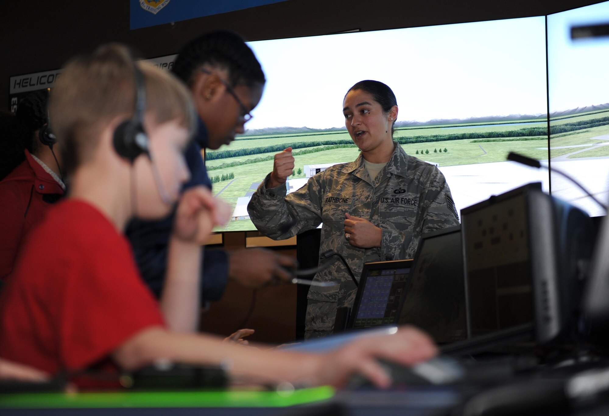 Tech. Sgt. Malena Rathbone, 334th Training Squadron air traffic control instructor, briefs school-aged children on the air traffic control simulator at Cody Hall during Biloxi Career Exploration Day Feb. 11, 2016, Keesler Air Force Base, Miss. The children also toured the 335th TRS weather facility, 81st Security Forces Squadron canine facility, 53rd Weather Reconnaissance Squadron and the Keesler Fire Department. (U.S. Air Force photo by Kemberly Groue)