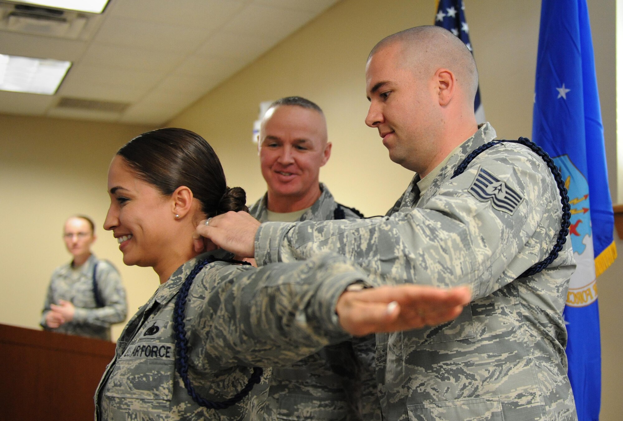 Tech. Sgt. Kyle Mullen, 81st Training Support Squadron military training leader course instructor, presents a blue rope to Staff Sgt. Jessica Ventura, 81st TRSS MTL course student, during a graduation ceremony at Lott Hall Feb. 11, 2016, Keesler Air Force Base, Miss. The first selected group of NCOs graduated the military training leader course after attending the nine-day class at Keesler. The program, formerly based out of Joint Base San Antonio-Lackland, Texas, is designed to mentor, train and lead Airmen in technical training as MTLs. (U.S. Air Force photo by Kemberly Groue)