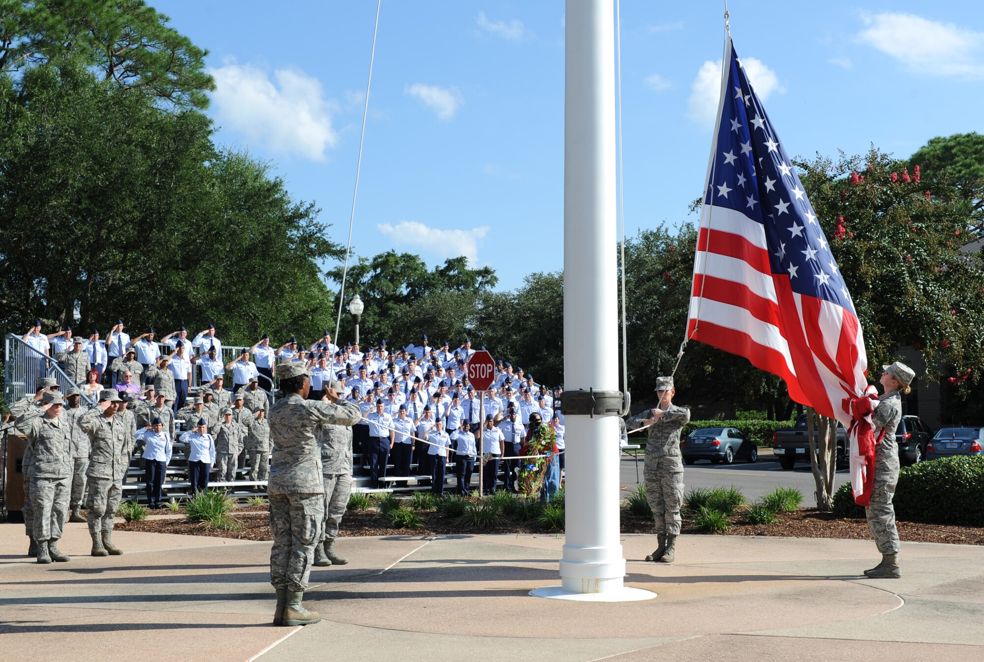 Keesler personnel lower the U.S. flag during a 9/11 memorial ceremony, Sept. 12, 2016, on Keesler Air Force Base, Miss. Fifteen years ago on Sept. 11, 2001, 19 terrorists simultaneously hijacked four passenger jets; flying one into the Pentagon in Washington, D.C., two into the World Trade Center in New York City, New York and one crashing outside of Shanksville, Pa. A total of 2,996 people were killed in the attacks.  (U.S. Air Force photo by Kemberly Groue)