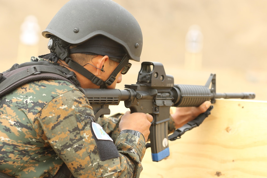 A Guatemala competitor fires his rifle during an assault team event May 4, 2016 as part of Fuerzas Comando 2016 in Ancon, Peru.  Fuerzas Comando is a U.S. Southern Command sponsered multinational special operations skills competition and fellowship program. (U.S. Army photo by Staff Sgt. Chad Menegay/Released)