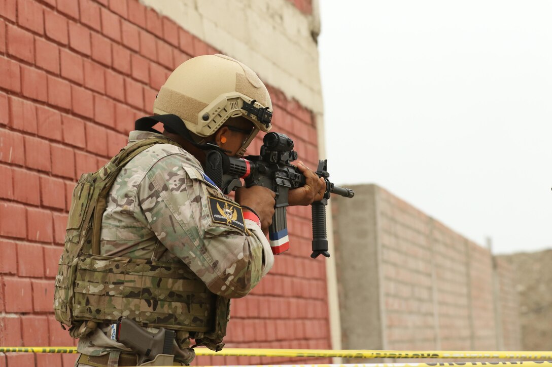 A Panama competitor aims his rifle during an assault team event May 4, 2016 as part of Fuerzas Comando 2016 in Ancon, Peru. Through friendly competition, this exercise promotes military-to-military relationships, increases training knowledge, and improves regional security. (U.S. Army photo by Staff Sgt. Chad Menegay/Released)