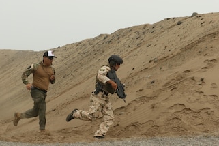 A Mexican competitor rounds a sand mound during the assault team event May 4, 2016 as part of Fuerzas Comando in Ancon, Peru.  Fuerzas Comando is a U.S. Southern Command sponsered multinational special operations skills competition and fellowship program. (U.S. Army photo by Staff Sgt. Chad Menegay/Released)