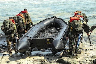 Uruguayan special operations competitors carry a Zodiac craft into the Pacific Ocean during a water event May 6, as part of Fuerzas Comando 2016 in Ancon, Peru. Fuerzas Comando is a U.S. Southern Command sponsored multinational special operations skills competition. (U.S. Army photo by Staff Sgt. Chad Menegay/Released)