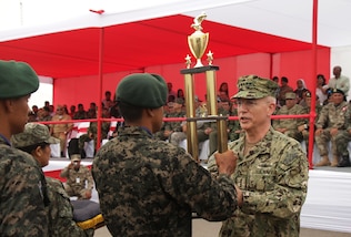 Navy Adm. Kurt W. Tidd, commander of U.S. Southern Command, presents the first place trophy to the Colombia team that won the Fuerzas Comando 2016 competition. Fuerzas Comando is a U.S. Southern Command sponsored multinational special operations skills competition. (Photo by Jose Ruiz, SOUTHCOM Public Affairs)