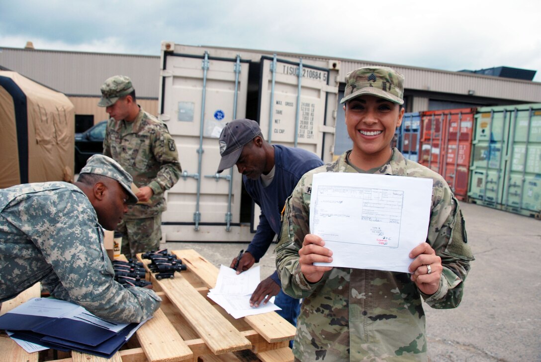 Army Sgt. Wendy Honeycutt, a supply sergeant for Fort Drum’s 2nd Battalion, 15th Field Artillery, proudly holds a form proving night vision scopes are no longer on her unit’s property book.