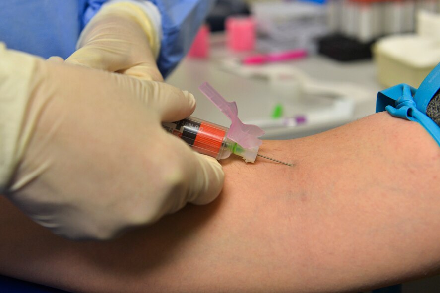 A 5th Medical Support Squadron medical laboratory technician draws blood from a patient at Minot Air Force Base, N.D., Dec. 13, 2016. Medical laboratory technicians conduct hematology, phlebotomy, urinalysis, chemistry and microbiology tests. (U.S. Air Force photo/Airman 1st Class Jessica Weissman)