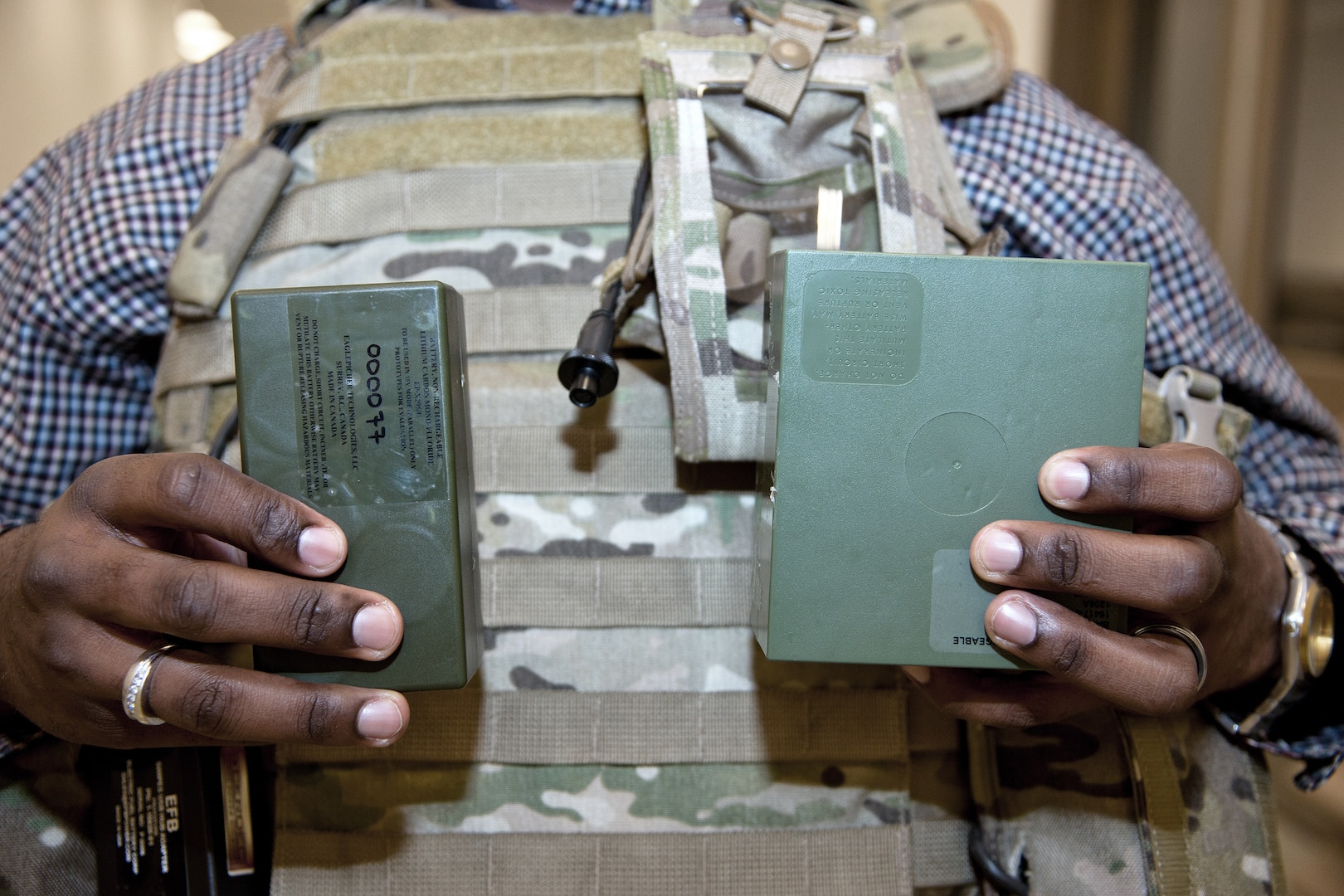 Christopher Hurley, an electronics engineer with the Army Research, Development and Engineering Command, holds a half-sized BA-5590 Battery, left, compared with the standard version. The standard battery has been a Warstopper Program item since the Gulf War.