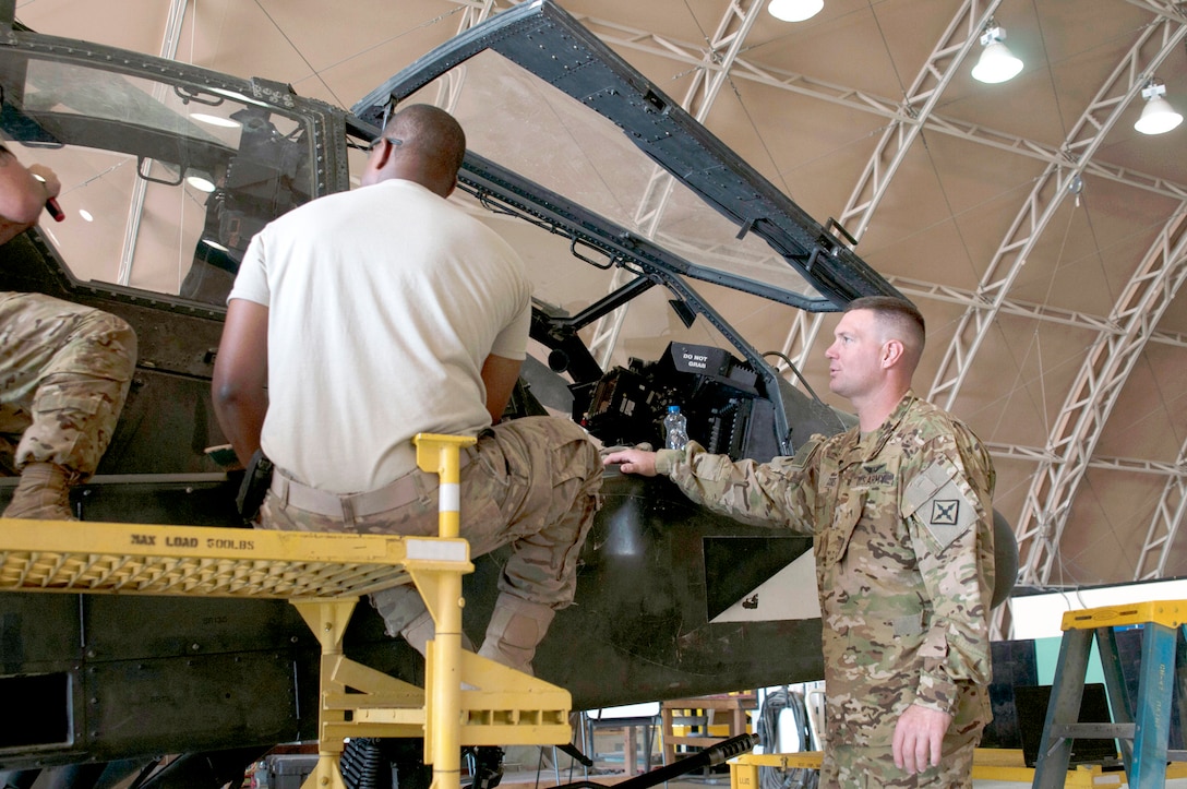 Soldiers from the Army National Guard’s 777th Aviation Support Battalion assess a windshield on an AH-64 Apache helicopter at Camp Buehring, Kuwait, September 18, 2016. The windshield is supported by the DLA Warstopper Program.