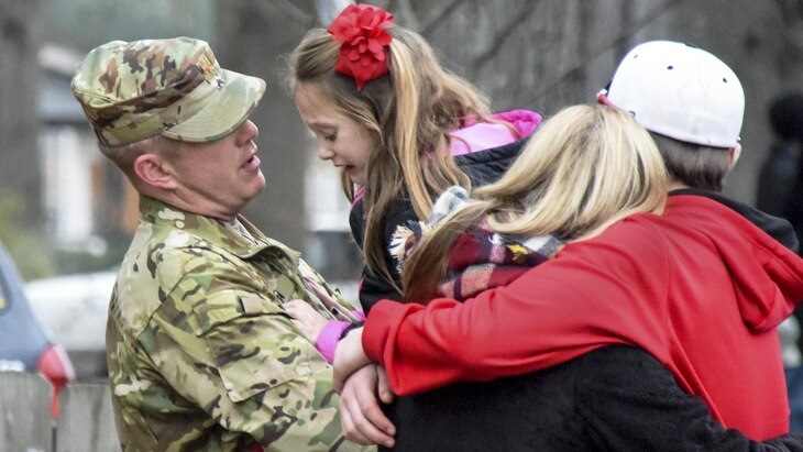 A soldier comforts his family after a deployment ceremony in Malvern, Ark., Jan. 1, 2017. The soldier is deploying to the Horn of Africa. Army photo by Sgt. Stephen Wright