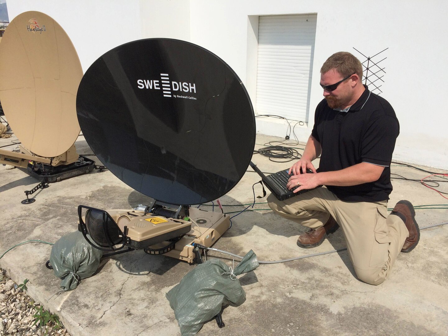 Mark Bossen, a contingency information technology specialist in DLA Information Operations, sets up the system relied on by members of JTF Matthew to communicate between the base location and field sites, as well as DLA Headquarters.
