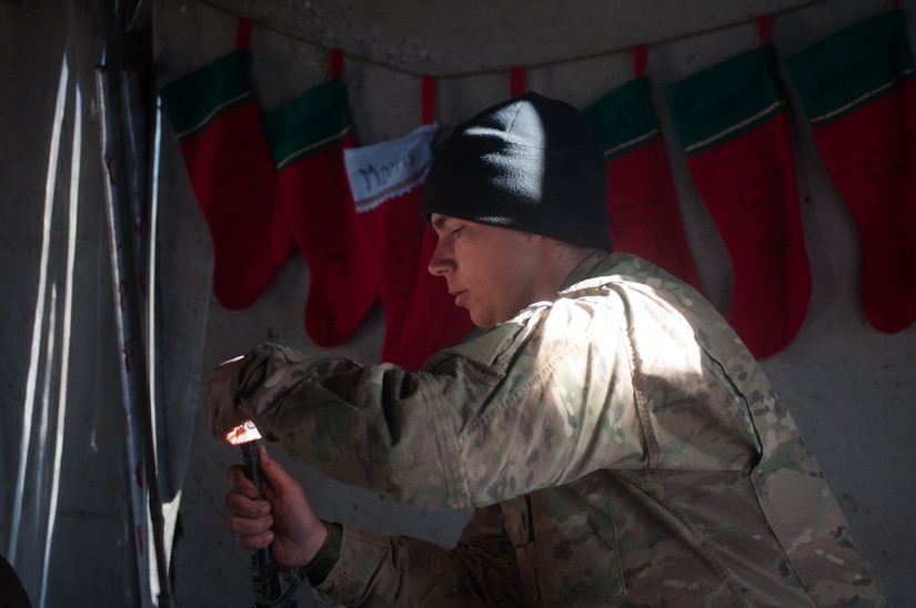 Army Spc. Tristan Trammel, Charlie Battery, 1st Battalion, 320th Field Artillery Regiment, Task Force Strike, cleans his weapon between fire missions in northern Iraq, Dec. 22, 2016. Battery C is supporting Iraqi forces with indirect fires in their fight against ISIL. Army photo by 1st Lt. Daniel Johnson