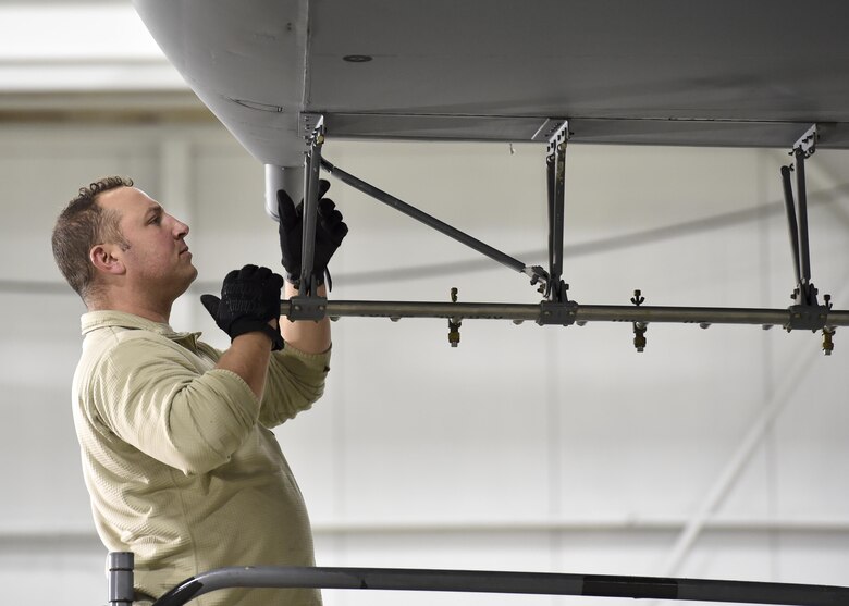 Tech. Sgt. Frank Serrao, an aerial spray maintenance craftsman with the 910th Maintenance Squadron, installs a wing boom for the Modular Aerial Spray System (MASS) on a Youngstown C-130H Hercules aircraft here, Jan. 4, 2017. The 910th Airlift Wing here operates the Department of Defense’s only aerial spray mission to control the spread of disease by eliminating pest insects, remove invasive vegetation and disperse oil spills in large bodies of water. The system typically uses booms that run through a port in the aircrew door, extending from the side of the aircraft. Aerial spray maintainers and operators still occasionally install and test the wing-mounted boom system to use for some applications. (U.S. Air Force photo/Eric White)