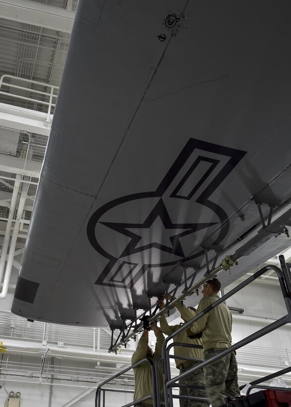 Master Sgt. Steven Feliz, Tech. Sgt. Frank Serrao and Tech. Sgt. Tom Neiswanger, all aerial spray maintainers with the 910th Maintenance Squadron, install a wing boom for the Modular Aerial Spray System (MASS) on a Youngstown C-130H Hercules aircraft here, Jan. 4, 2017. The 910th Airlift Wing operates the Department of Defense’s only aerial spray mission to control the spread of disease by eliminating pest insects, remove invasive vegetation and disperse oil spills in large bodies of water. The system typically uses booms that run through a port in the aircrew door, extending from the side of the aircraft. Aerial spray maintainers and operators still occasionally install and test the wing-mounted boom system to use for some applications. (U.S. Air Force photo/Eric White)