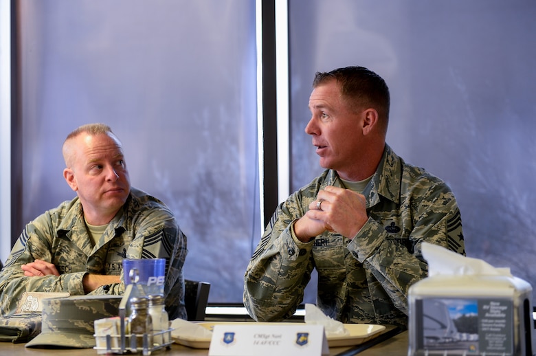 Chief Master Sgt. Craig Neri, (right) 14th Air Force Command Chief Master Sergeant, speaks during a luncheon with Airmen in the Satellite Dish dining facility at Schriever Air Force Base, Colorado, Tuesday, Jan. 3, 2017. Neri answered Airmen questions and addressed concerns going into the new year. (U.S. Air Force photo/Christopher DeWitt)