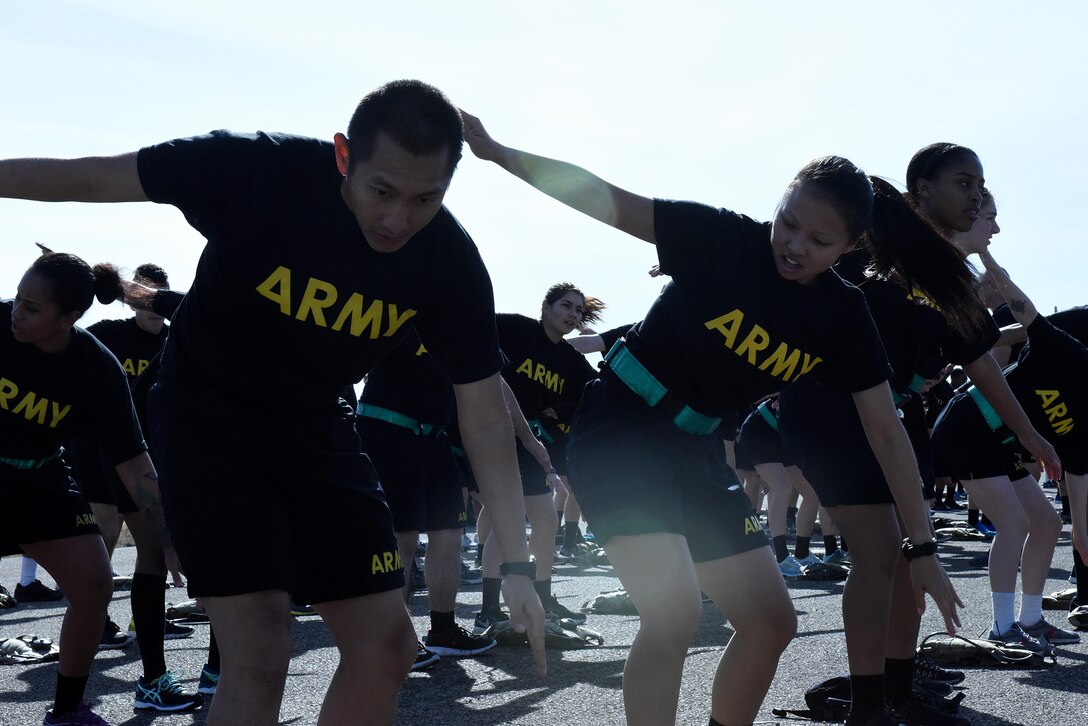 U.S. Army 344th Military Intelligence Battalion soldiers warm up before the 17th Training Group formation run on the flightline at Goodfellow Air Force Base, Texas, Jan. 3, 2017. The 17th TRG held the formation run to foster inter-service cooperation and kick off the new year. (U.S. Air Force photo by Airman 1st Class Caelynn Ferguson/ Released)