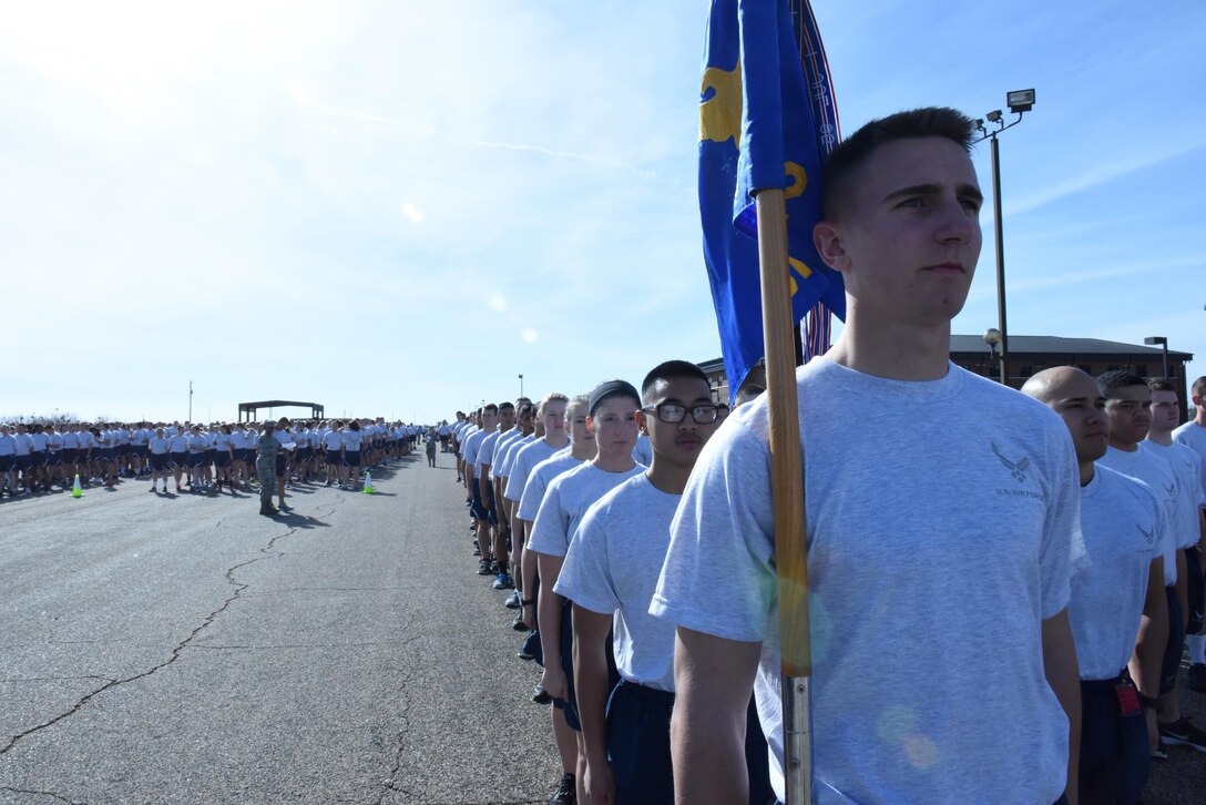 U.S. Air Force Airmen stand in formation before the 17th Training Group formation run on the flightline at Goodfellow Air Force Base, Texas, Jan. 3, 2017. Every unit within the 17th TRG and the 344th Military Intelligence Battalion participated in the run. (U.S. Air Force photo by Airman 1st Class Caelynn Ferguson/Released)