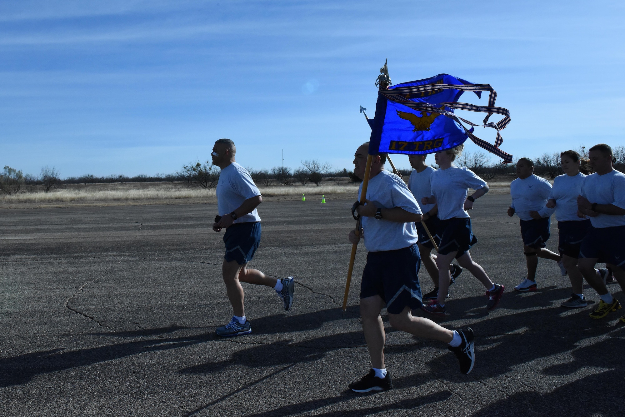 U.S. Air Force Col. Alex Ganster, 17th Training Group Commander, and Chief Master Sgt. Jesus Longoria, 312th Training Squadron superintendent, head the 17th TRG formation run on the flightline at Goodfellow Air Force Base, Texas, Jan. 3, 2017. Participants in the run ranged from TDY students, instructors, 344th Military Intelligence Battalion, 17th Training Support Squadron and 17th TRG permanent party personnel. (U.S. Air Force photo by Airman 1st Class Caelynn Ferguson/ Released)