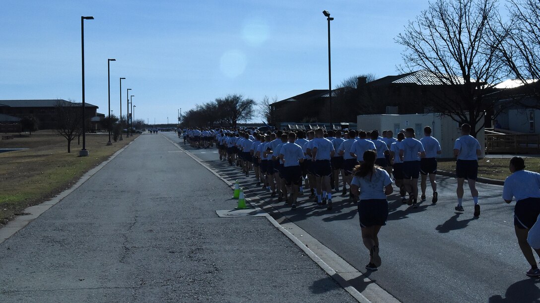 U.S. Air Force Airmen run in formation during the 17th Training Group formation run at Goodfellow Air Force Base, Texas, Jan. 3, 2017. The formation run spanned a distance of 1.8 miles and included around 2,000 participants. (U.S. Air Force photo by Airman 1st Class Caelynn Ferguson/ Released)