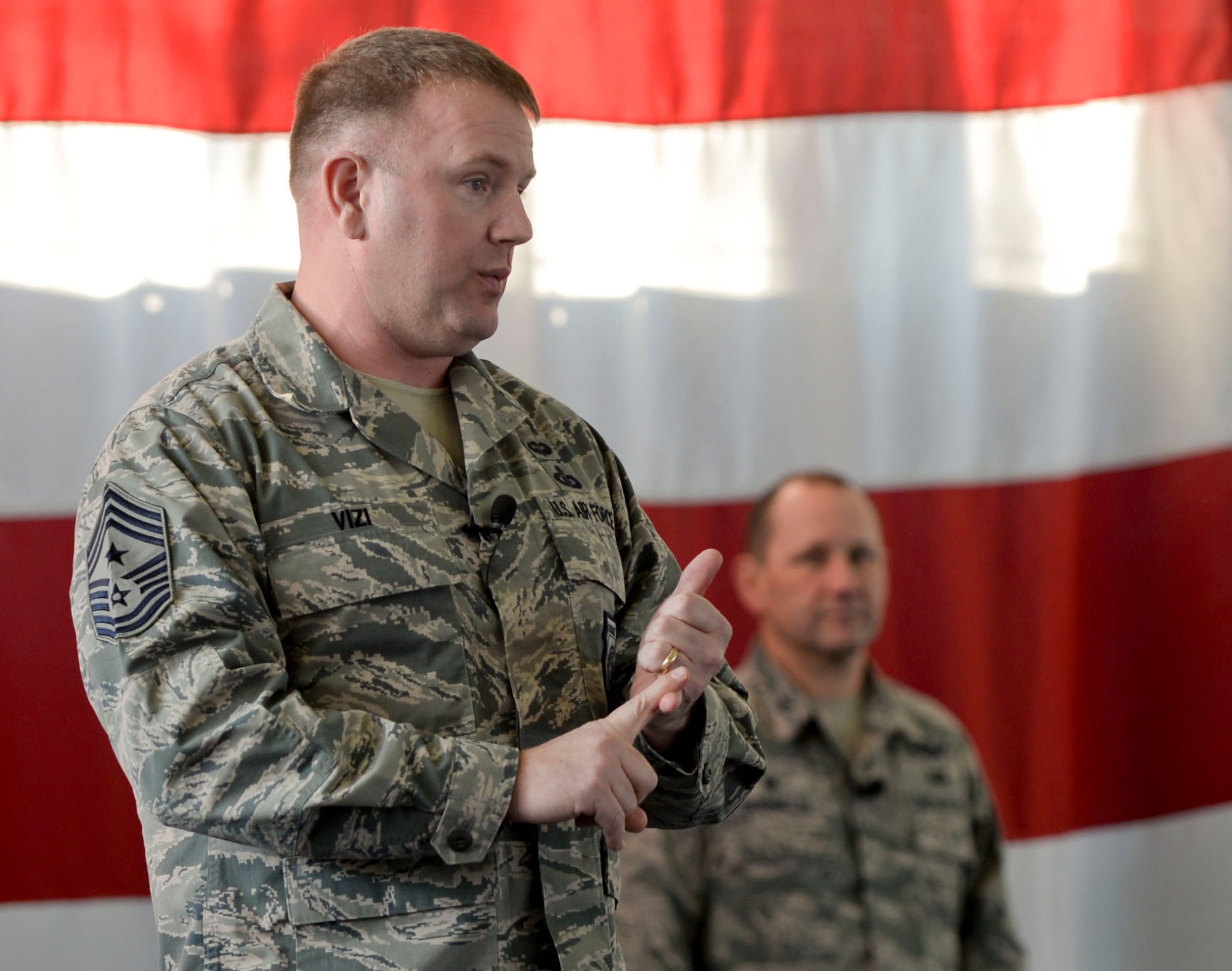 Chief Master Sgt. Adam Vizi, command chief of the 28th Bomb Wing, speaks at his first all-call as Ellsworth’s command chief inside the Pride Hangar on Jan. 3, 2017. During the first all-call of the year, Vizi and Col. Gentry Boswell, the commander of the 28th BW, discussed how the Air Force is tackling manning and funding issues as well as focusing on the importance of developing squadrons as the building block of the Air Force. (U.S. Air Force photo by Airman 1st Class Randahl J. Jenson)