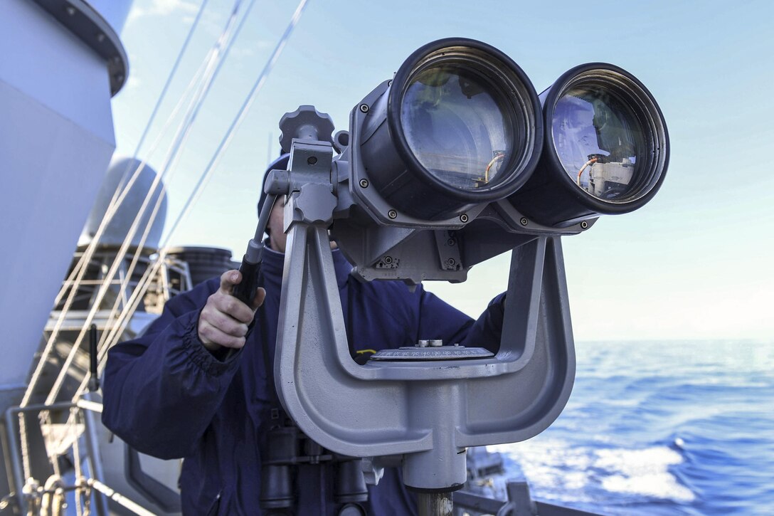 Navy Petty Officer 3rd Class Austin Flynn looks through binoculars aboard the USS Donald Cook in the Strait of Messina, Jan. 1, 2017. The guided-missile destroyer is conducting naval operations in the U.S. 6th Fleet area of operations to support U.S. national security interests in Europe and Africa. Navy photo by Petty Officer 3rd Class Alyssa Weeks
