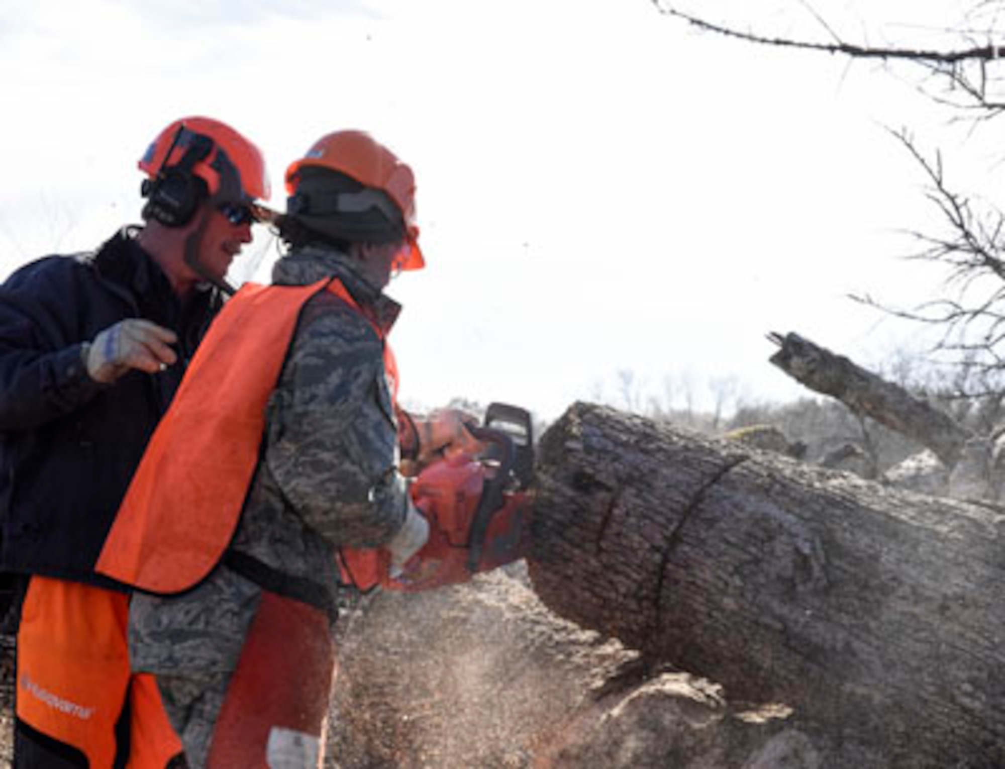 Mr. Greg Hutchison, a volunteer with the Arkansas Baptist State Convention Disaster Relief organization instructs a member of the Rapid Augmentation Team on the proper use of a chainsaw Dec. 20, 2016, at Little Rock Air Force Base, Ark. The training ensured more than 30 R.A.T. volunteers are prepared to handle any situation that may arise during a call to active duty for a state emergency. (U.S. Air National Guard photo by Tech. Sgt. Jessica Condit)