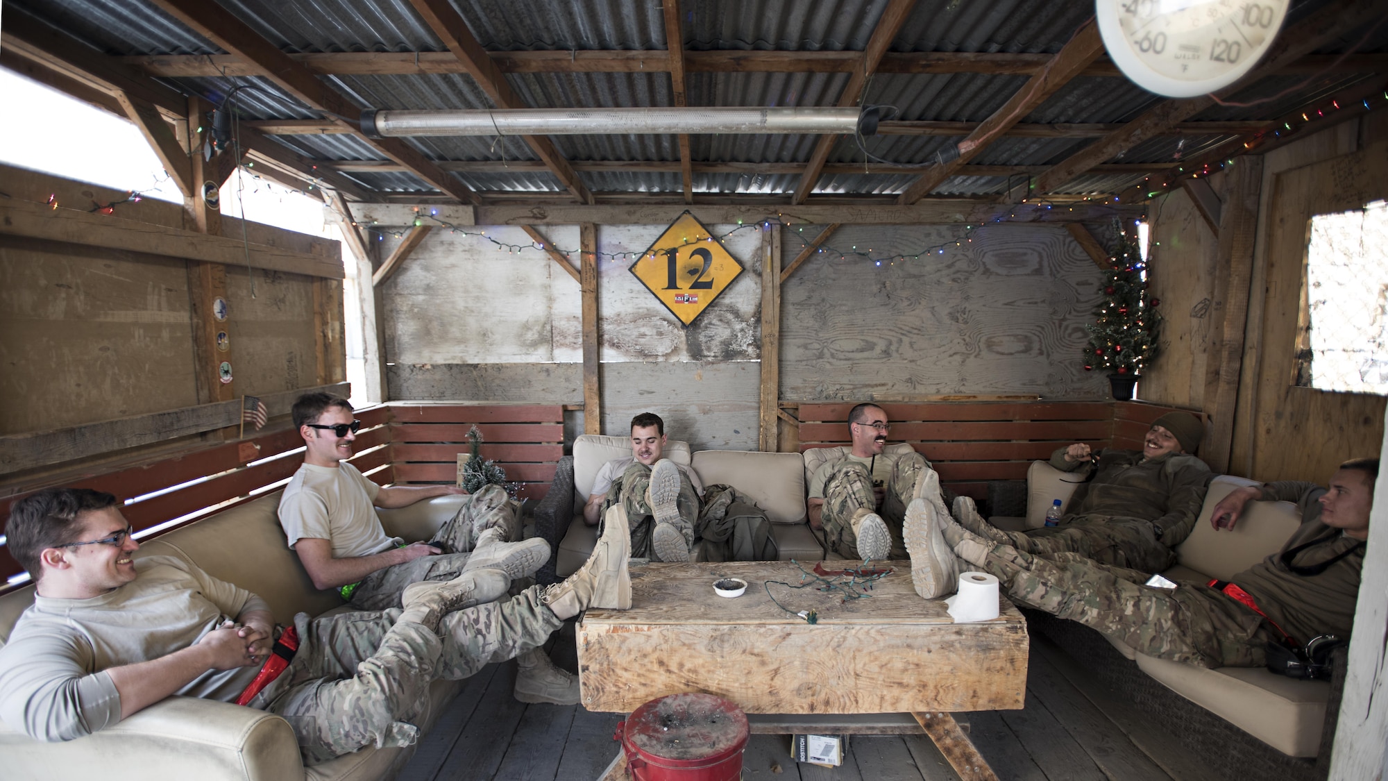 Members of the 455th Expeditionary Aircraft Maintenance Squadron celebrate the completion of their new hang-out spot on Thanksgiving, Nov. 24, 2016 at Bagram Airfield, Afghanistan. Units around Bagram do their best to make the deployed location feel like home by decorating, building places to relax and playing games. (U.S. Air Force photo by Staff Sgt. Katherine Spessa)