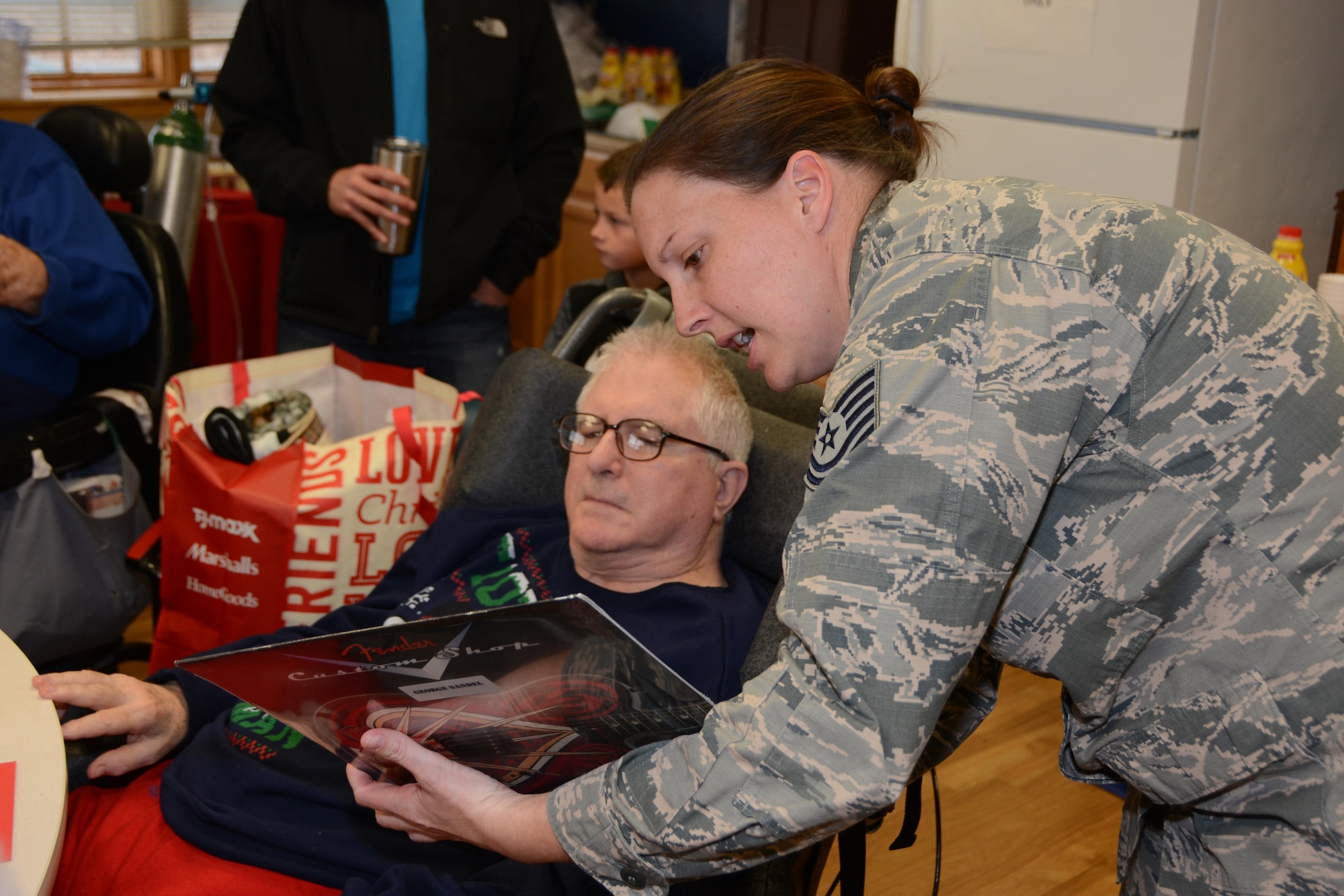 Tech. Sgt. Stephanie Heath, 507th Mission Support Group administrative assistant, shows a Veteran one of his Christmas gifts during the annual Norman Veterans Center Christmas Party at the Norman Veterans Center in Norman, Okla., Dec. 22, 2016. This year marked the 21st year that the 507th Air Refueling Wing has participated in the annual Christmas party at the center. (U.S. Air Force photo/Maj. Jon Quinlan)
