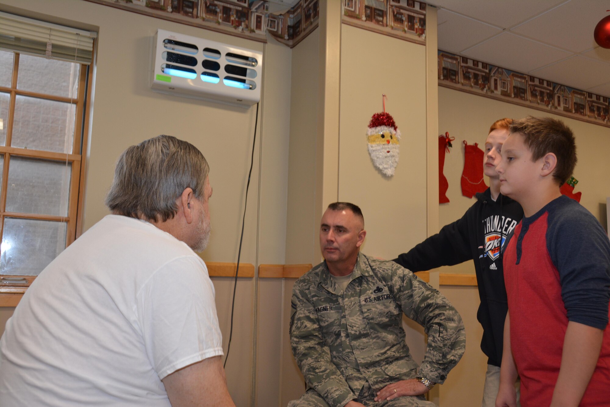 Master Sgt. Jon Russell of the 507th Maintenance Squadron delivers a gift bag and listens to Norman Veterans Center resident talk about his time in the U.S. Army Dec. 22, 2016 in Norman, Okla. (U.S. Air Force photo/Maj. Jon Quinlan)