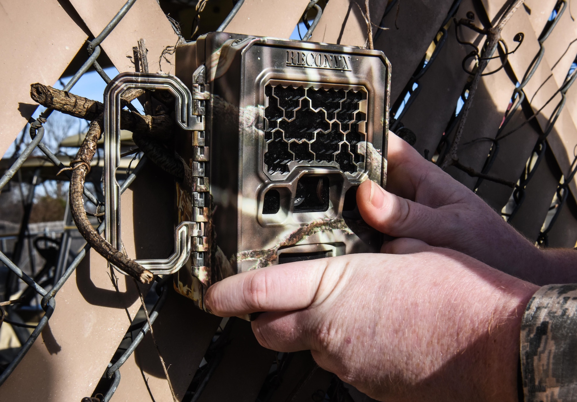 Airman 1st Class Corrin Fiene, 2nd Civil Engineer Squadron pest management apprentice, installs a camera near a trap at Barksdale Air force Base, La., January 3, 2017. The wildlife cameras were supplied by Barksdale’s Natural Resources office to aid in spotting and trapping wild dogs on base. (U.S. Air force photo/Senior Airman Luke Hill)