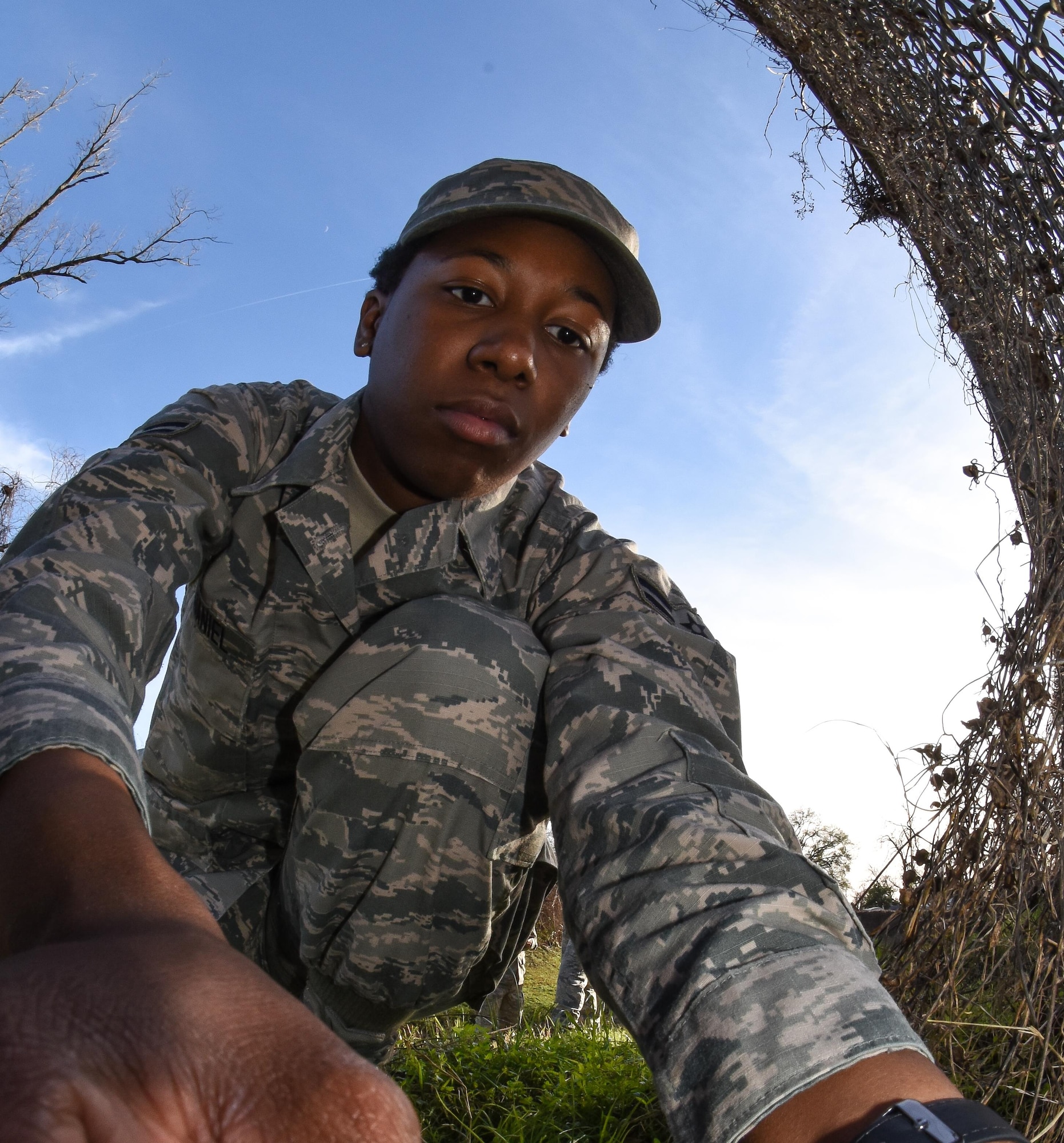 Airman 1st Class Amber McDaniel, 2nd Civil Engineer Squadron pest management journeyman, installs a trap near an entry point that wild dogs have been using to access Barksdale Air Force Base, La., Jan. 3, 2017. Once caught, the wild dogs are removed from base quickly and safely. (U.S. Air force photo/Senior Airman Luke Hill)