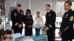 (From left) Brig. Gen. Jeffrey Johnson, Brooke Army Medical Center commanding general; Command Sgt. Maj. Tabitha Gavia, Regional Health Command-Central command sergeant major; Maj. Gen. Thomas Tempel, RHC-C commanding general; and BAMC Command Sgt. Maj. Albert Crews, deliver a gift basket to a Brooke Army Medical Center patient and his wife at Joint Base San Antonio-Fort Sam Houston Dec. 25, 2016. They were joined by BAMC deputy commanders and their families to deliver gift baskets to patients Christmas morning at Brooke Army Medical Center. The command team and their families, joined by Lt. Gen. Jeffrey S. Buchanan, U.S. Army North commanding general, also served Christmas dinner to patients and staff in the dining room.