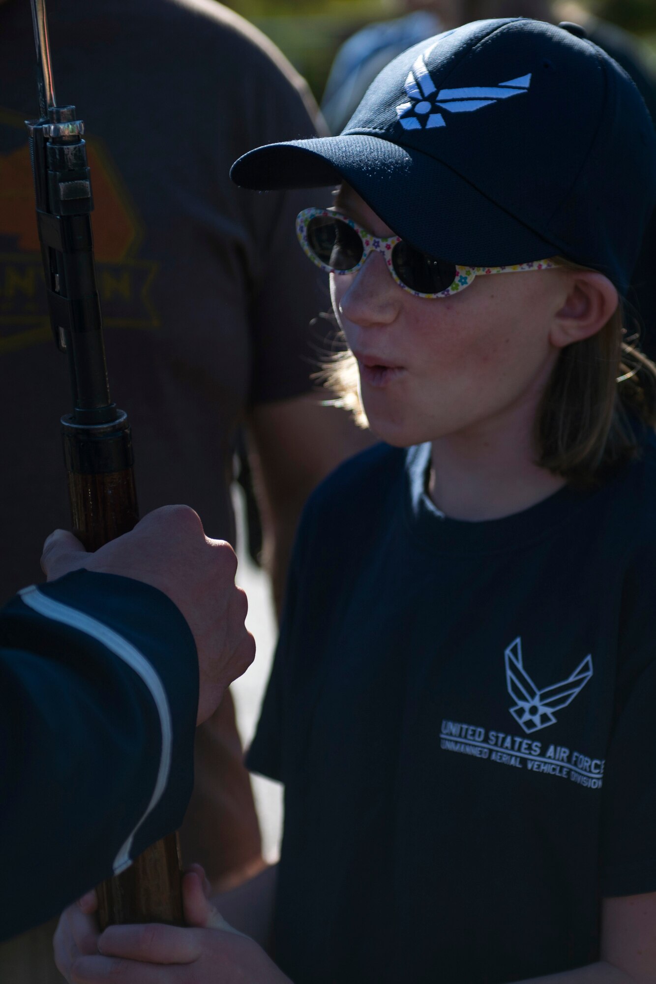 A Sea World guest holds a U.S. Air Force Honor Guard Drill Team drill rifle after a performance in San Diego, Calif., Dec. 29, 2016. The drill team showcases their drill performances at public venues, such as Sea World, to recruit and inspire the public. (U.S. Air Force photo by Senior Airman Philip Bryant)