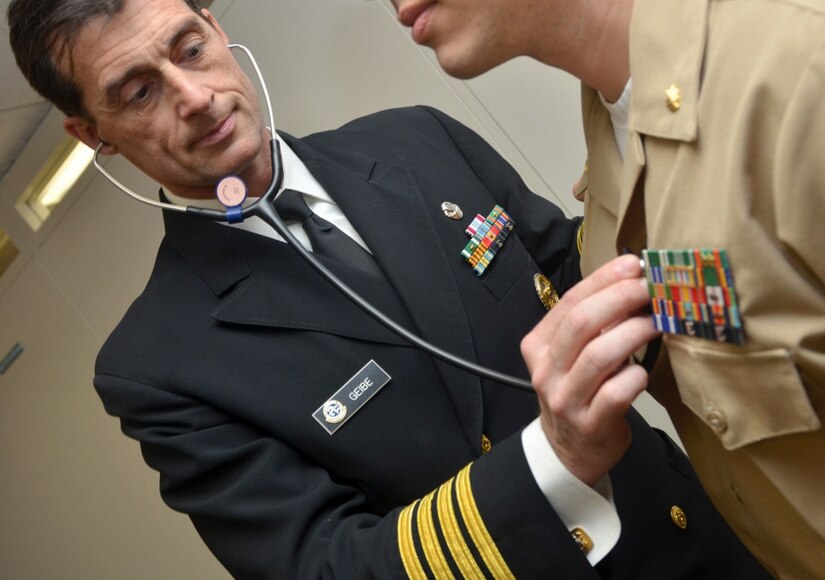 Navy Capt. Jesse Geibe, Naval Hospital Jacksonville director for public health, listens to a patient’s heart rate. The Jacksonville Business Journal honored Geibe as a 2016 Health Care Hero. Defense Department officials are reminding military and civilian employees that they must report their health care coverage to the Internal Revenue Service when they file their 2016 federal income tax form. Navy photo by Jacob Sippel