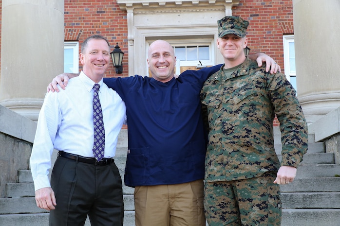 Joseph Klocek (left) and Maj. Scott Graniero (right) pose with Master Sgt. Clifford Farmer at Marine Corps Systems Command aboard Marine Corps Base Quantico, Va. Farmer credits the support and compassion of the two men—part of his leadership team at MCSC—with saving his life during a time when he contemplated suicide. Today, Farmer battles post-traumatic stress disorder and depression, and urges leaders across the Marine Corps to show understanding and compassion for Marines who may be suffering. (U.S. Marine Corps photo by Monique Randolph)