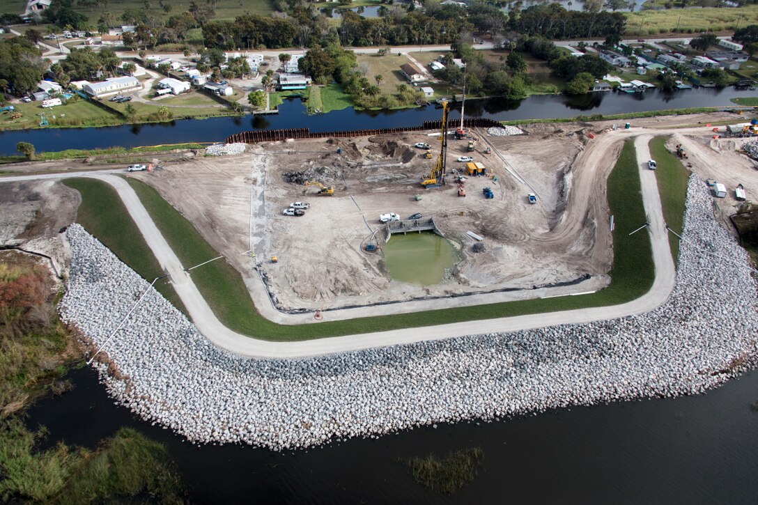 With a cofferdam in place (foreground), crews work to excavate material from Herbert Hoover Dike at the Culvert 8 work site near the city of Okeechobee. Culvert 8 is one of 28 water control structures the U.S. Army Corps of Engineers is replacing as part of its efforts to rehabilitate the dike that surrounds Lake Okeechobee.  