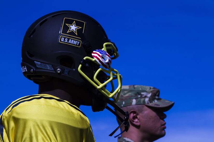 A U.S. Army All-American athlete and a Soldier mentor observe the joint East/West practice Jan. 3, at Heroes Stadium, San Antonio. Soldier mentors are selected because they have excelled in their personal and professional endeavors, are paired with AAB participants to share their personal stories of perseverance, selfless-service and excellence with the All-Americans. The practice was held in preparation for the 2017 U.S. Army All-American Bowl, which will kick off Jan. 7, at the San Antonio Alamodome, and will be broadcast live on NBC at 12 p.m. CST. The U.S. Army All-American Bowl is the nation's premier high school football game and it provides a platform for Soldiers to engage with students, families and community officials while showcasing the Army’s latest innovations in technology and its ongoing commitment to the development of America’s future leaders. (U.S. Army Reserve photo by Spc. James Lefty Larimer, 367th Mobile Public Affairs Detachment)